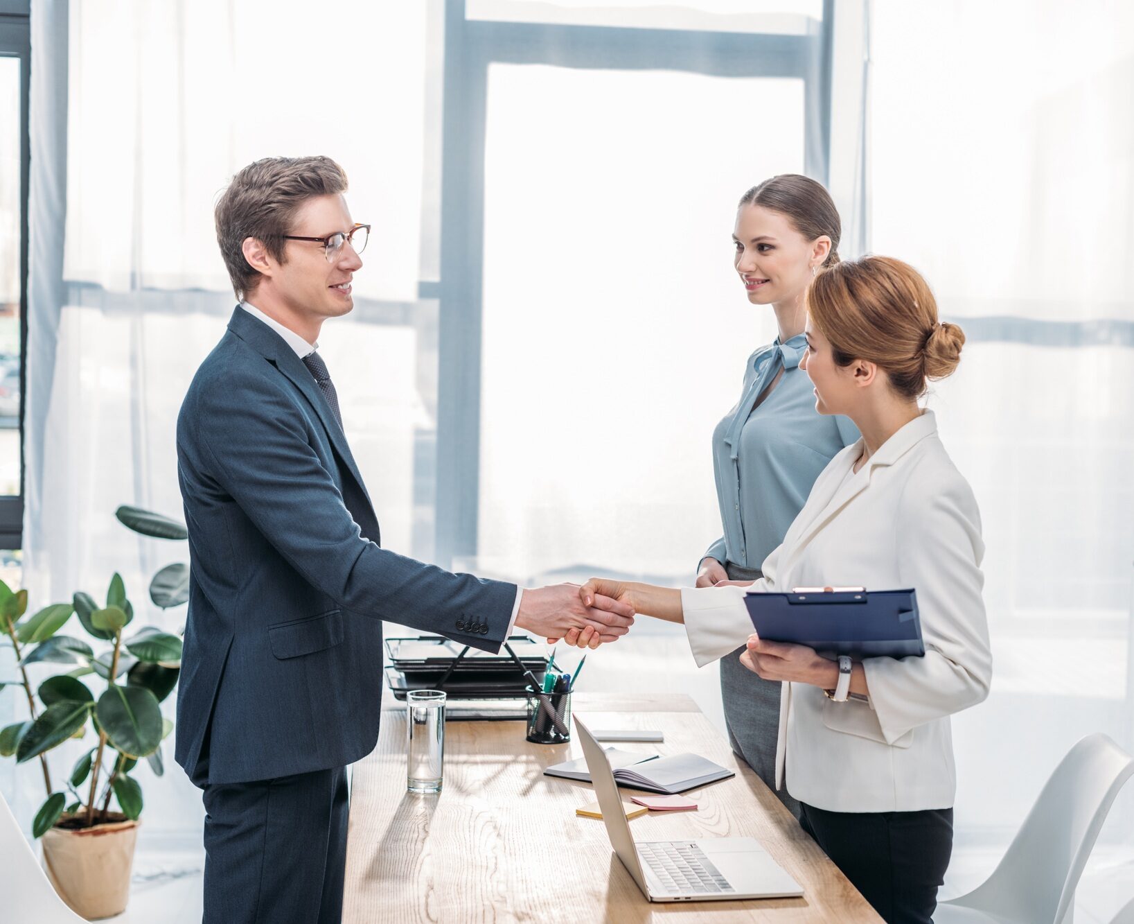 happy employee shaking hands with recruiter on job interview